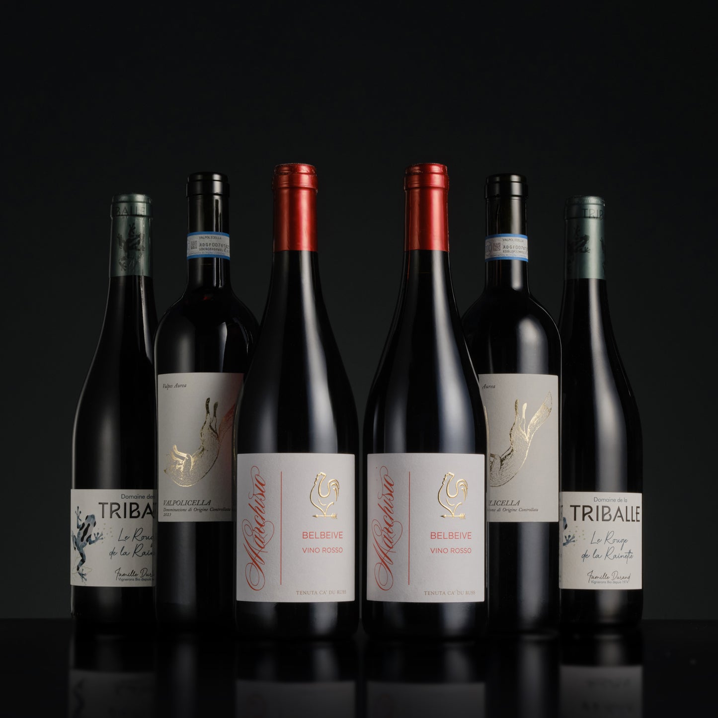 Collection of wine bottles with visible labels on a black background