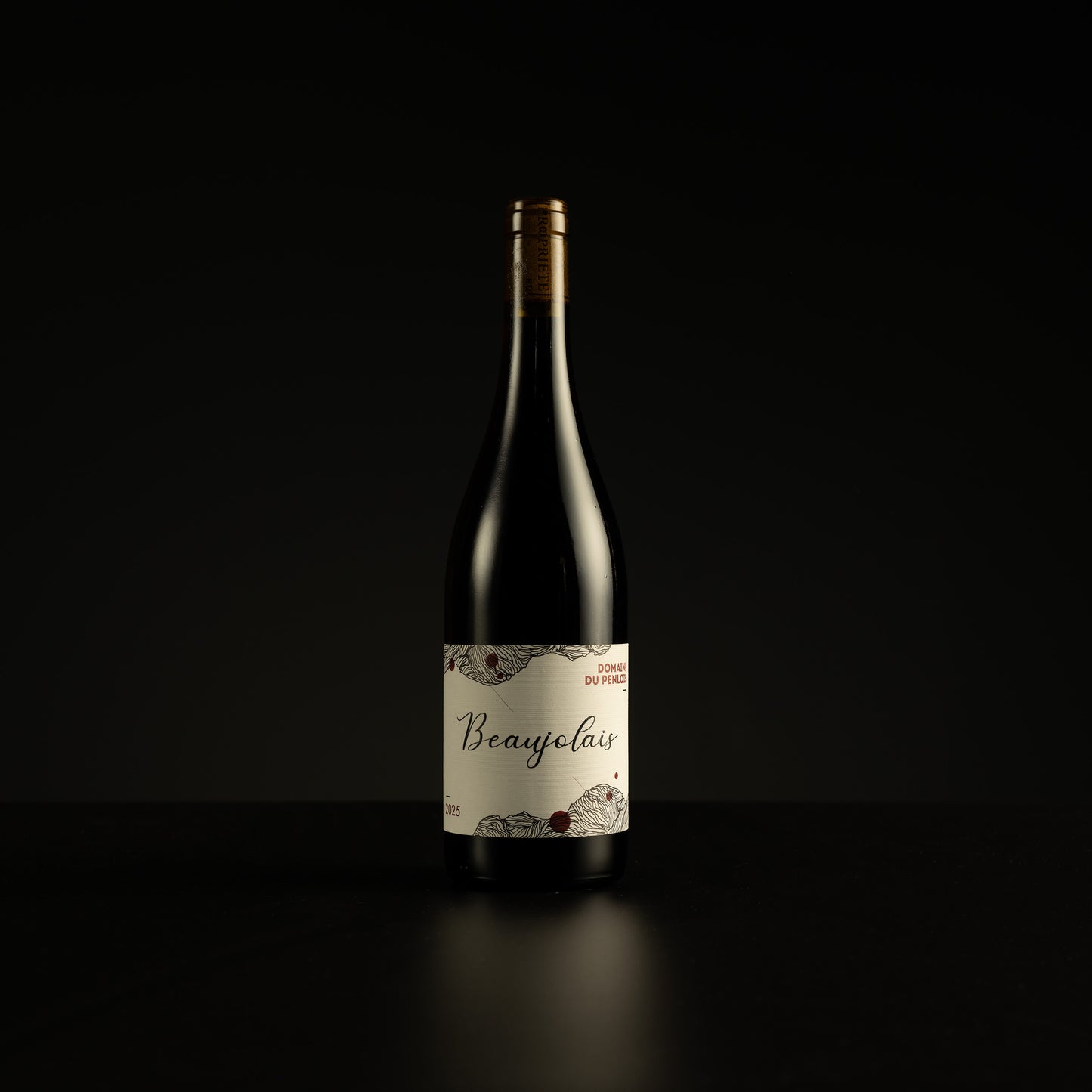 Wine bottle labeled 'Beaujolais' on a black background