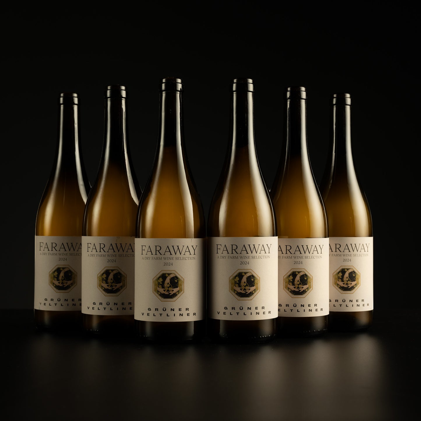 Row of Faraway wine bottles with labels on a black background