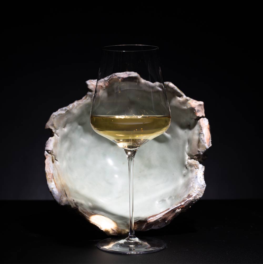 White wine in glass with ceramic background