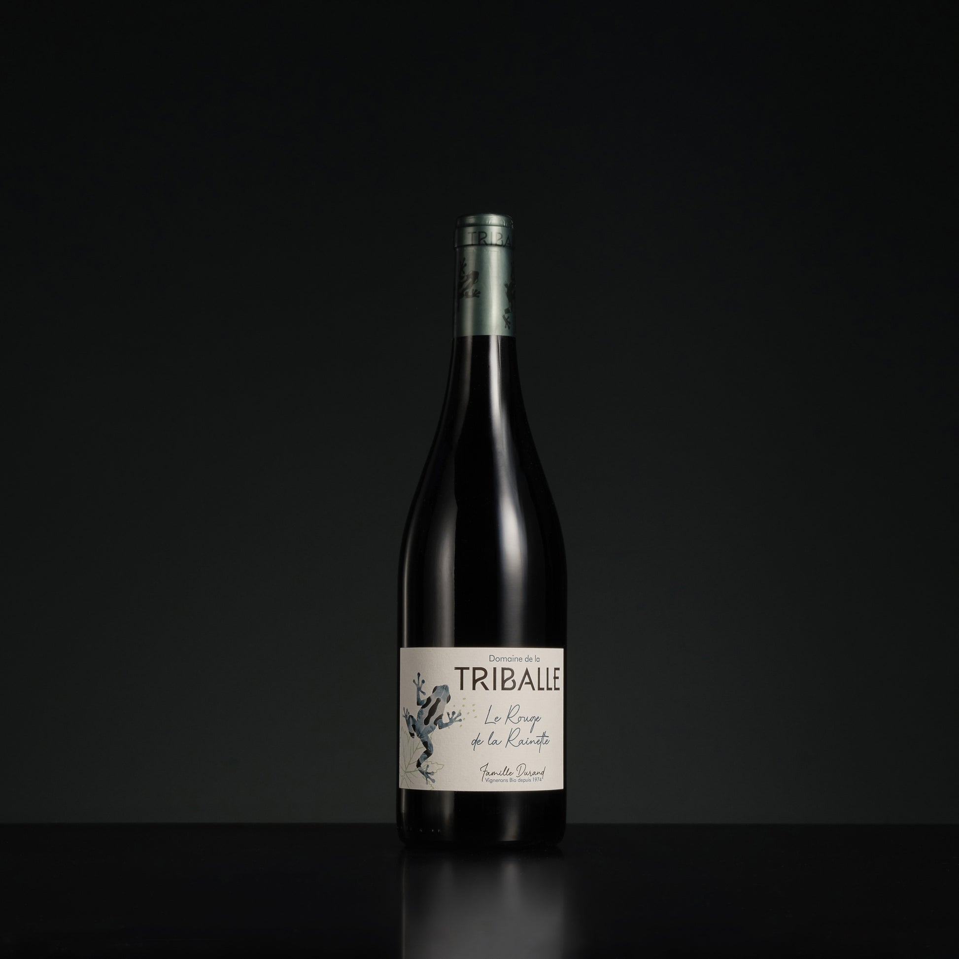 Wine bottle with 'Triballe' label on a black background