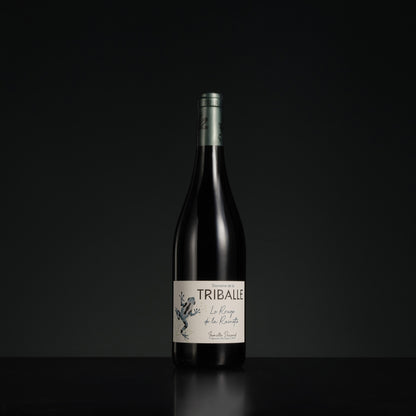 Wine bottle with 'Triballe' label on a black background