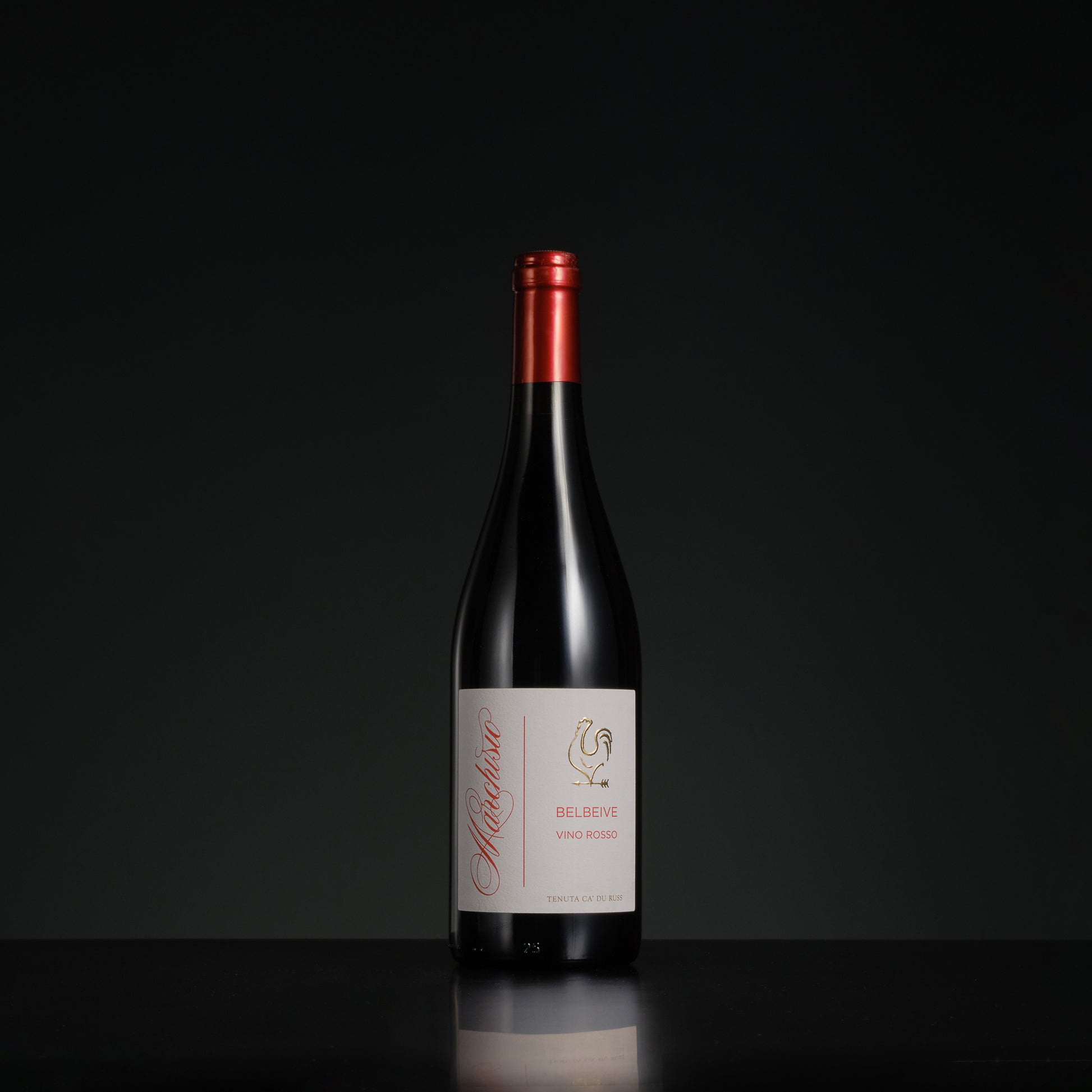 Red wine bottle with a visible label on a black background