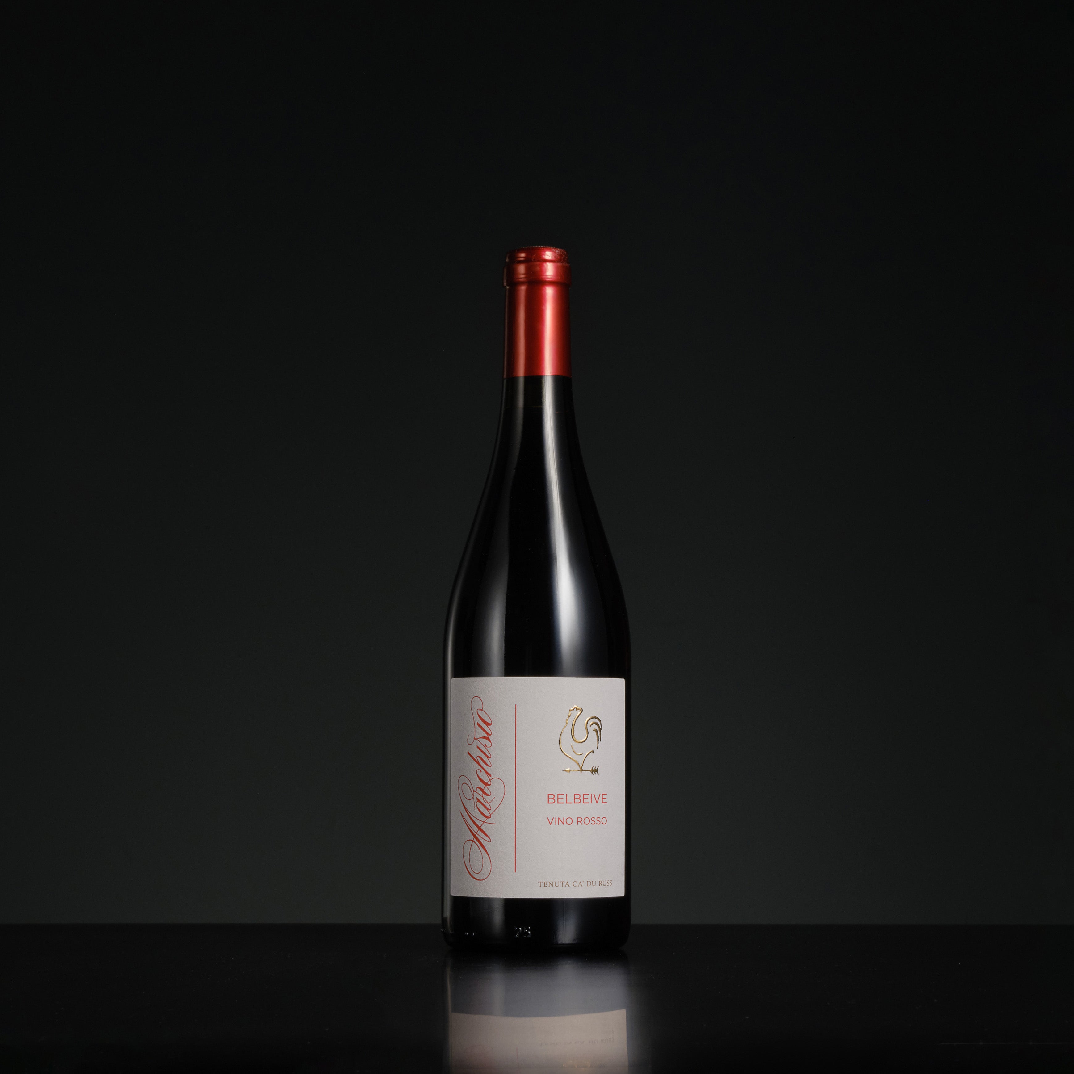 Red wine bottle with a visible label on a black background