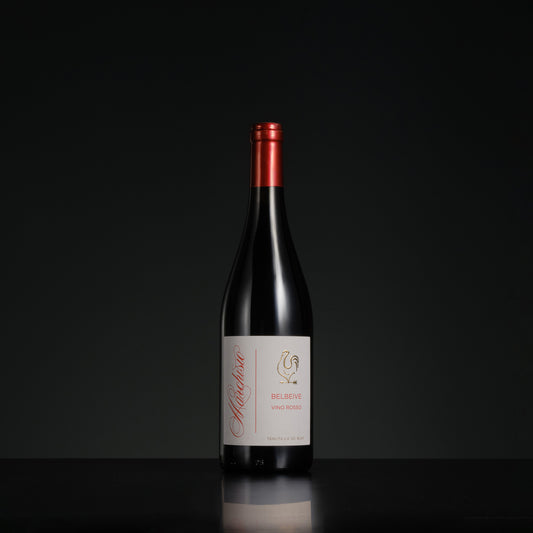 Red wine bottle with a visible label on a black background