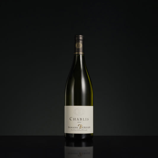 Bottle of Chablis wine on a black background