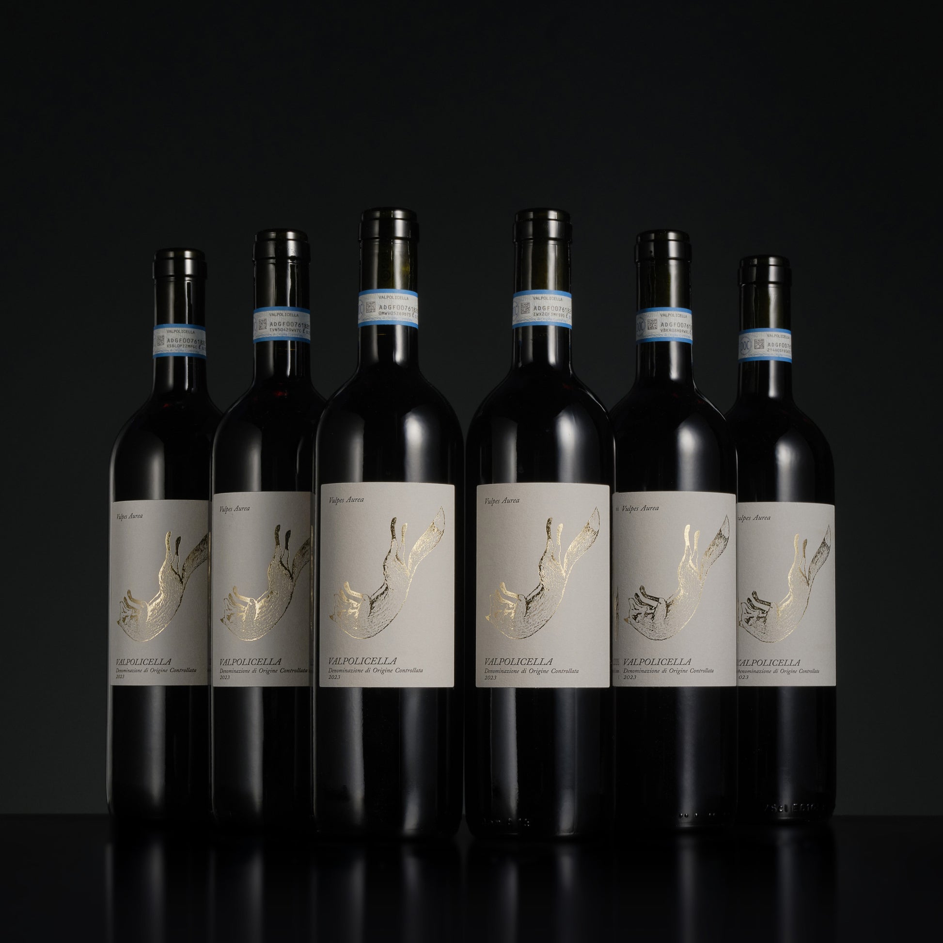 Seven bottles of wine with labels on a black background