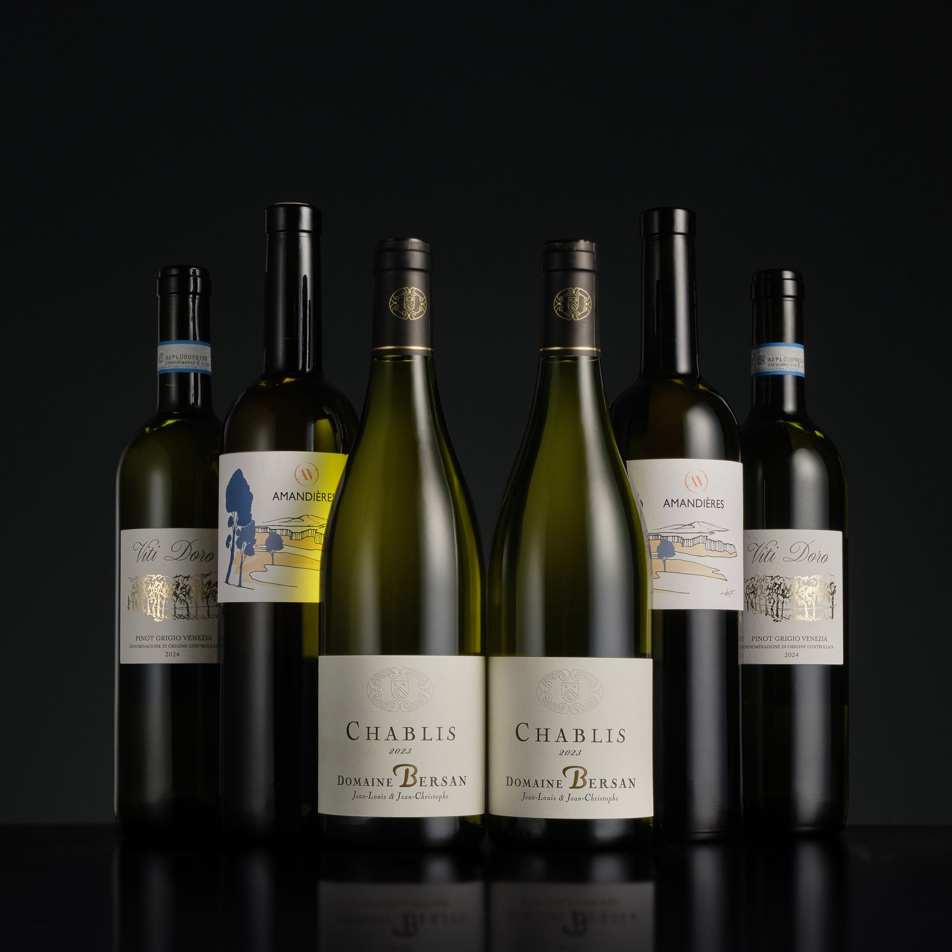 Collection of Domaine Bersan Chablis wine bottles on a black background