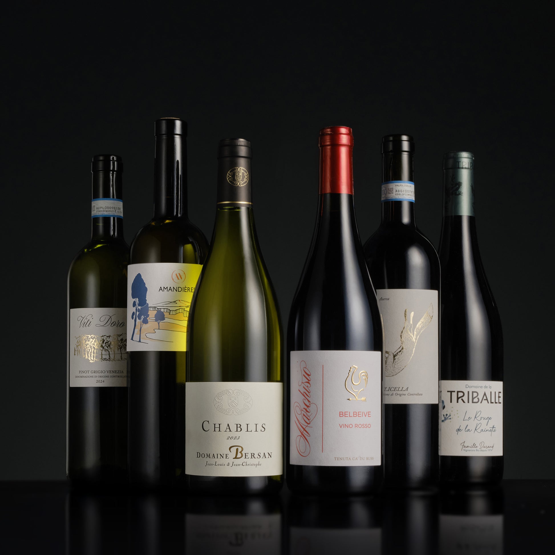 Collection of wine bottles with labels on a black background