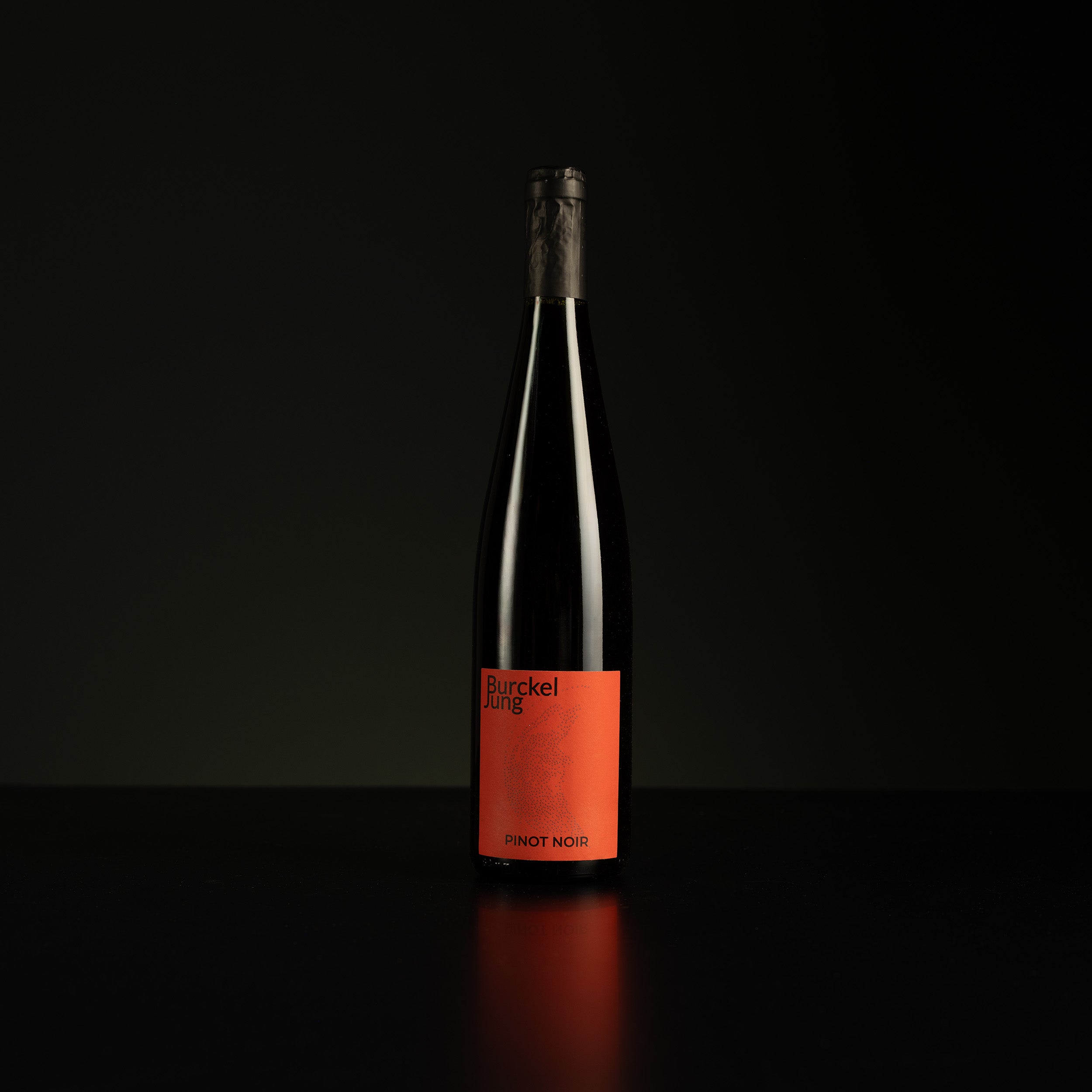 Wine bottle with an orange label on a black background