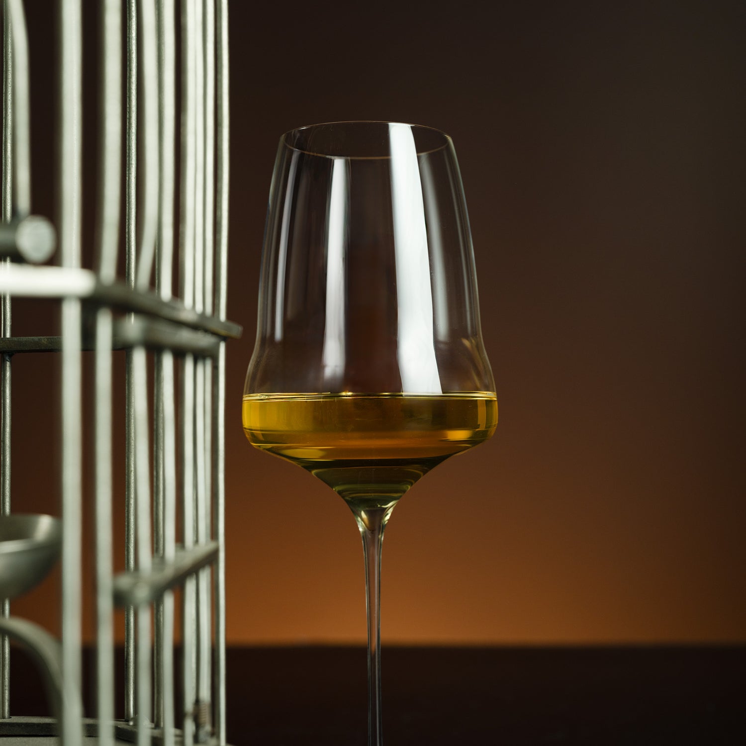 Wine glass with amber liquid on a dark background