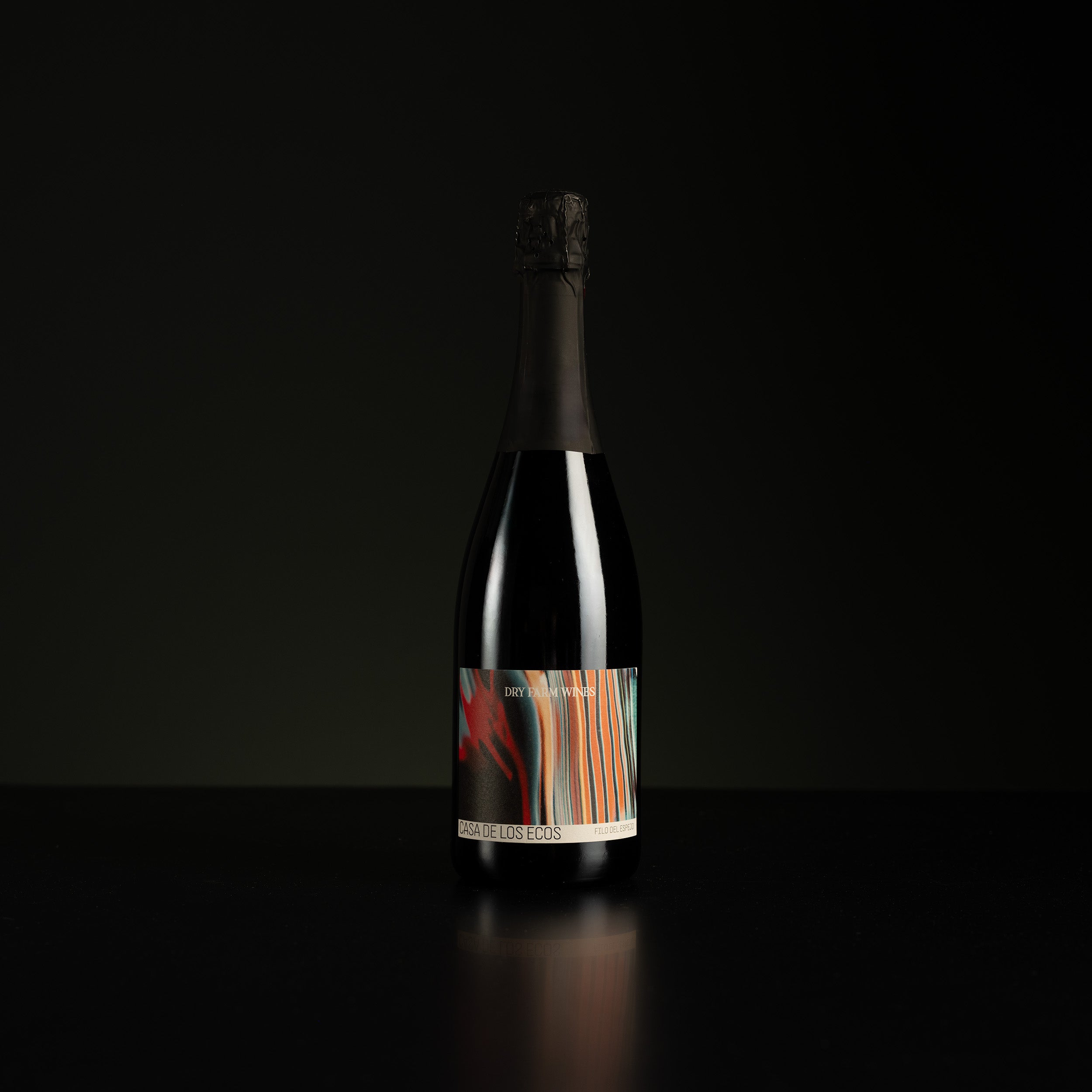 Bottle of wine with a colorful label on a black background