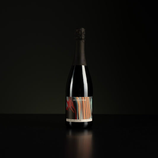 Bottle of wine with a colorful label on a black background