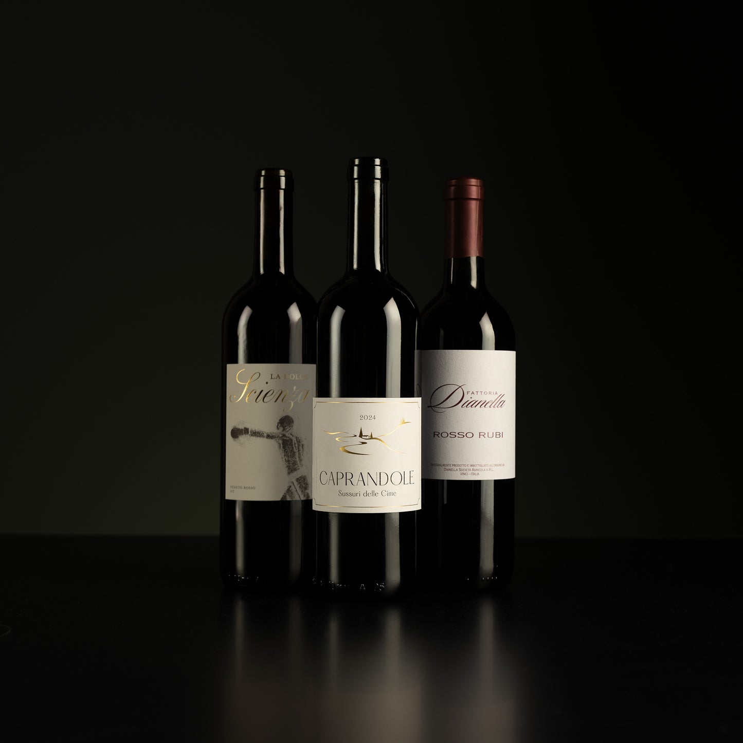 Three wine bottles with labels on a black background
