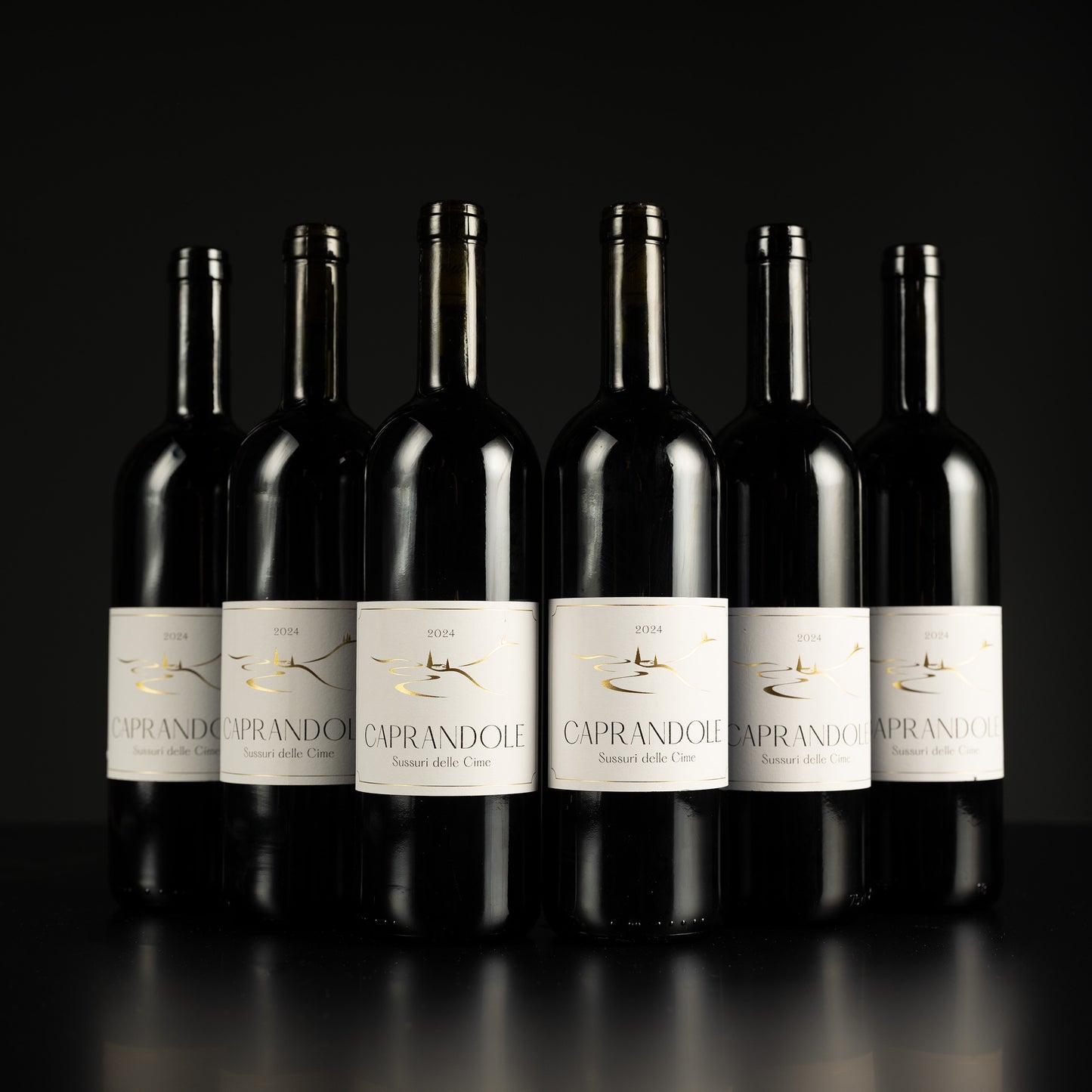 Row of Caprandole wine bottles on a black background