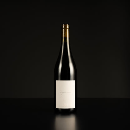 Wine bottle with a label on a black background