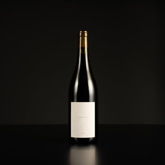 Wine bottle with a label on a black background