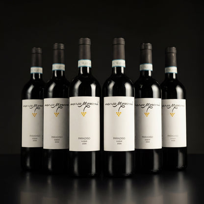 Row of wine bottles with white labels on a black background