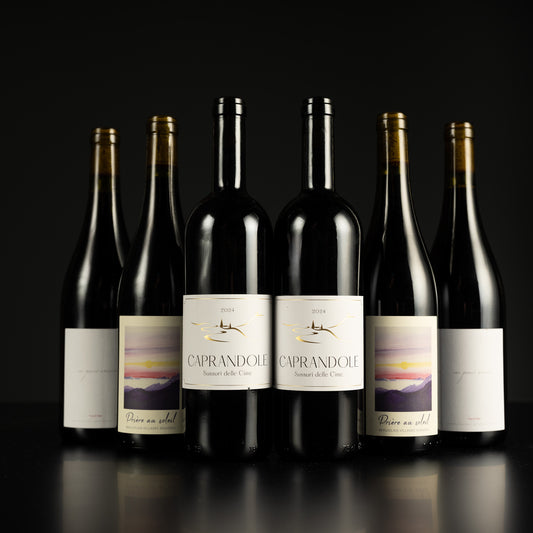 Six bottles of Caprandolo wine on a black background