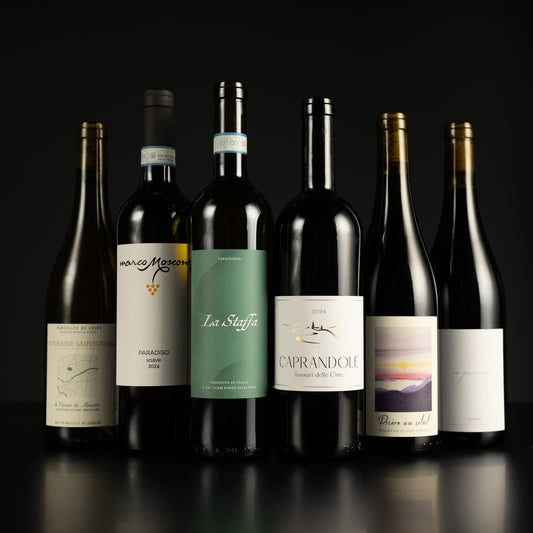Collection of wine bottles with labels on a dark background