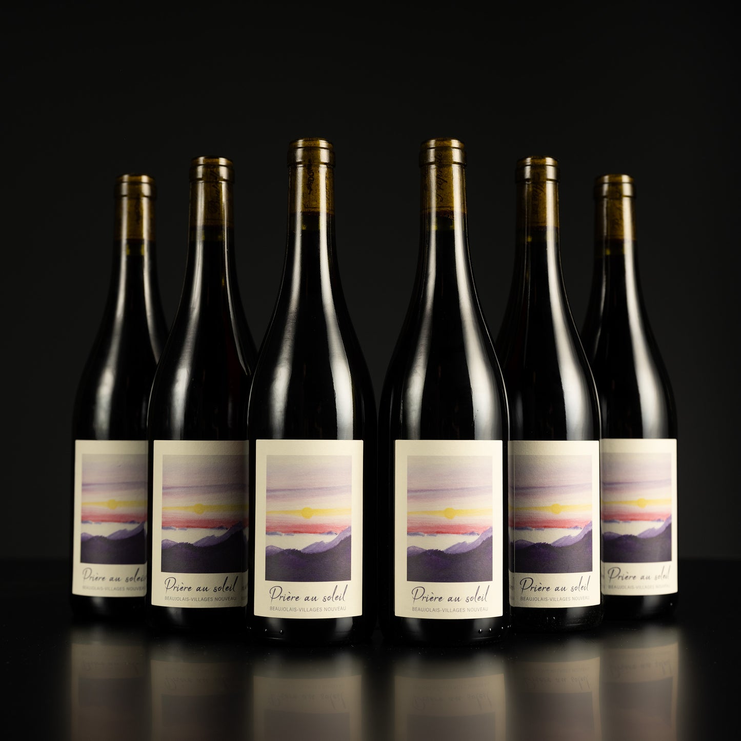 Six bottles of wine with labels on a black background