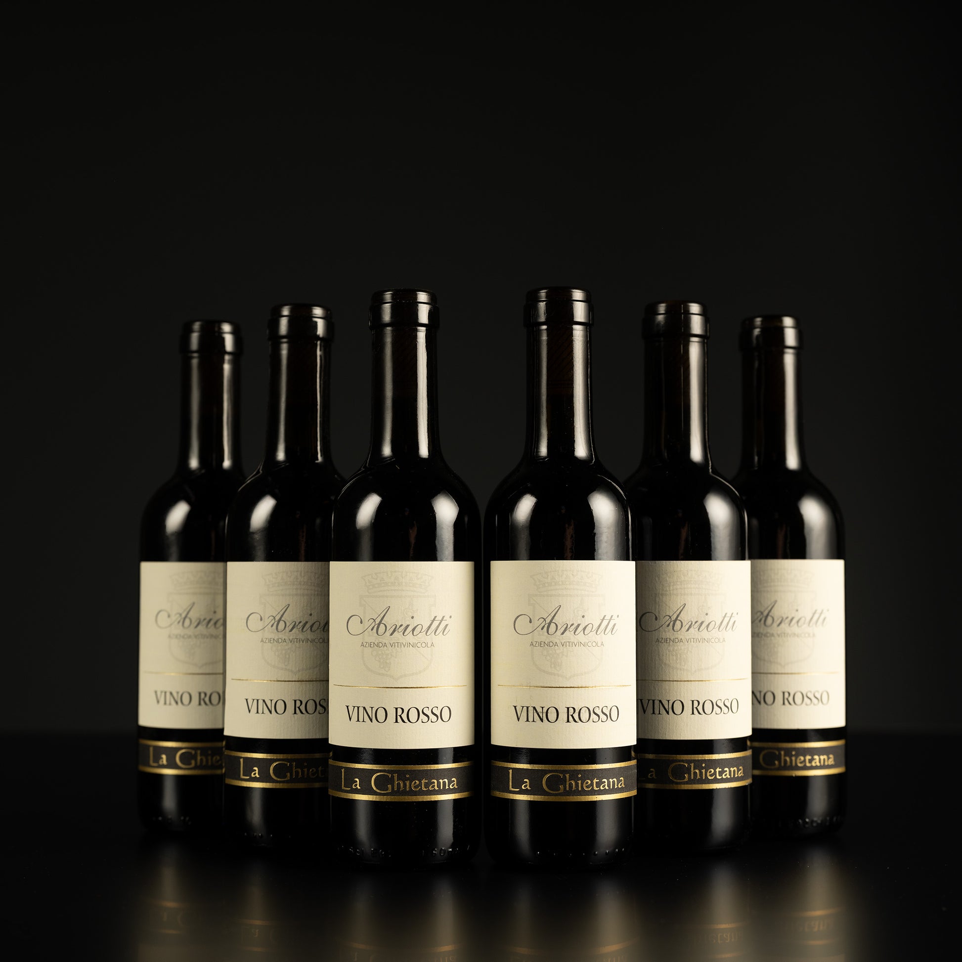 Row of wine bottles with 'Ariietti' labels on a black background