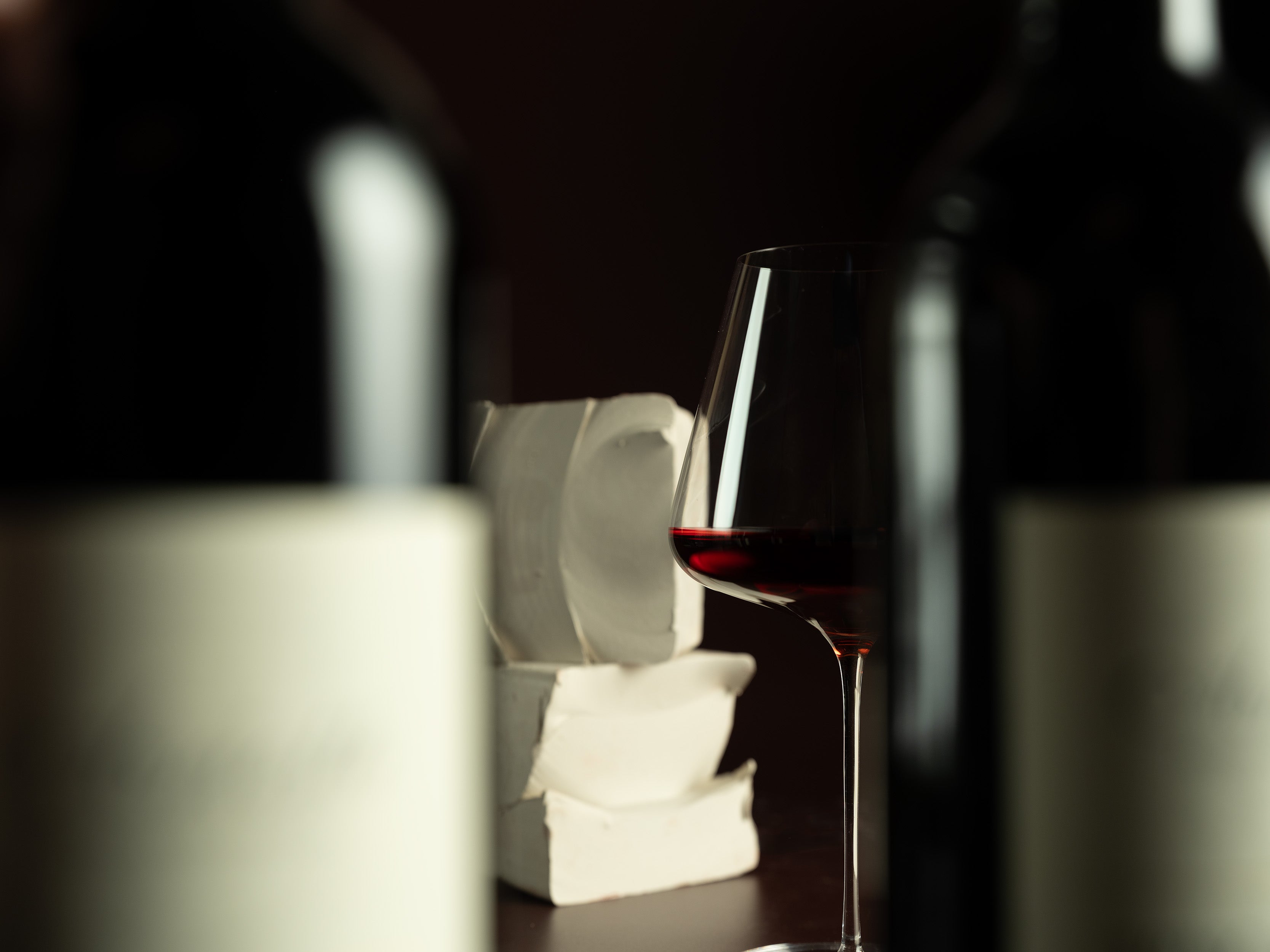 Wine glass with red wine on a dark background