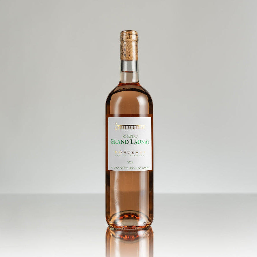 Bottle of Chateau Grand Launay wine on a gray background