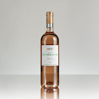 Bottle of Chateau Grand Launay wine on a gray background
