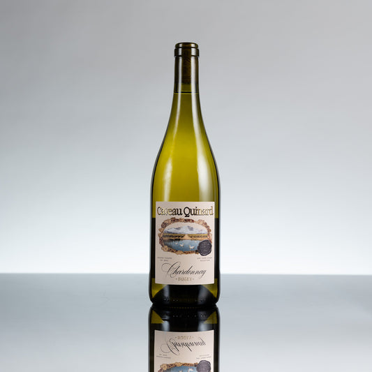 Wine bottle with a label on a reflective surface and gray background