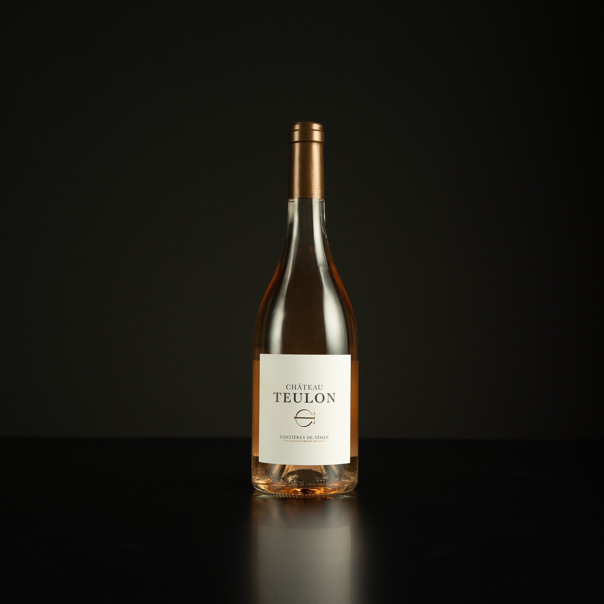 Wine bottle labeled 'Chateau Teulon' on a black background