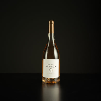 Wine bottle labeled 'Chateau Teulon' on a black background