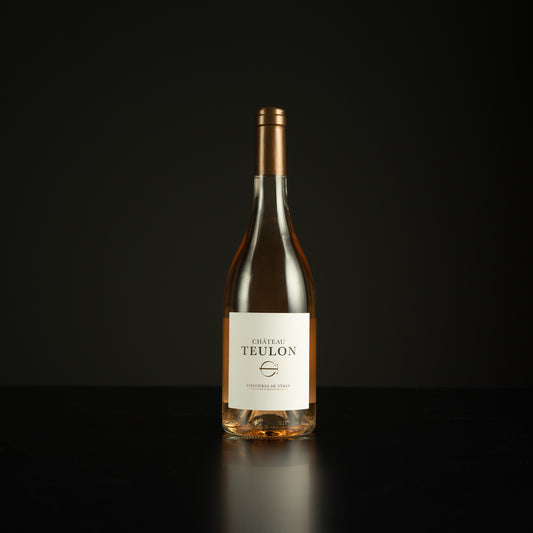 Wine bottle labeled 'Chateau Teulon' on a black background