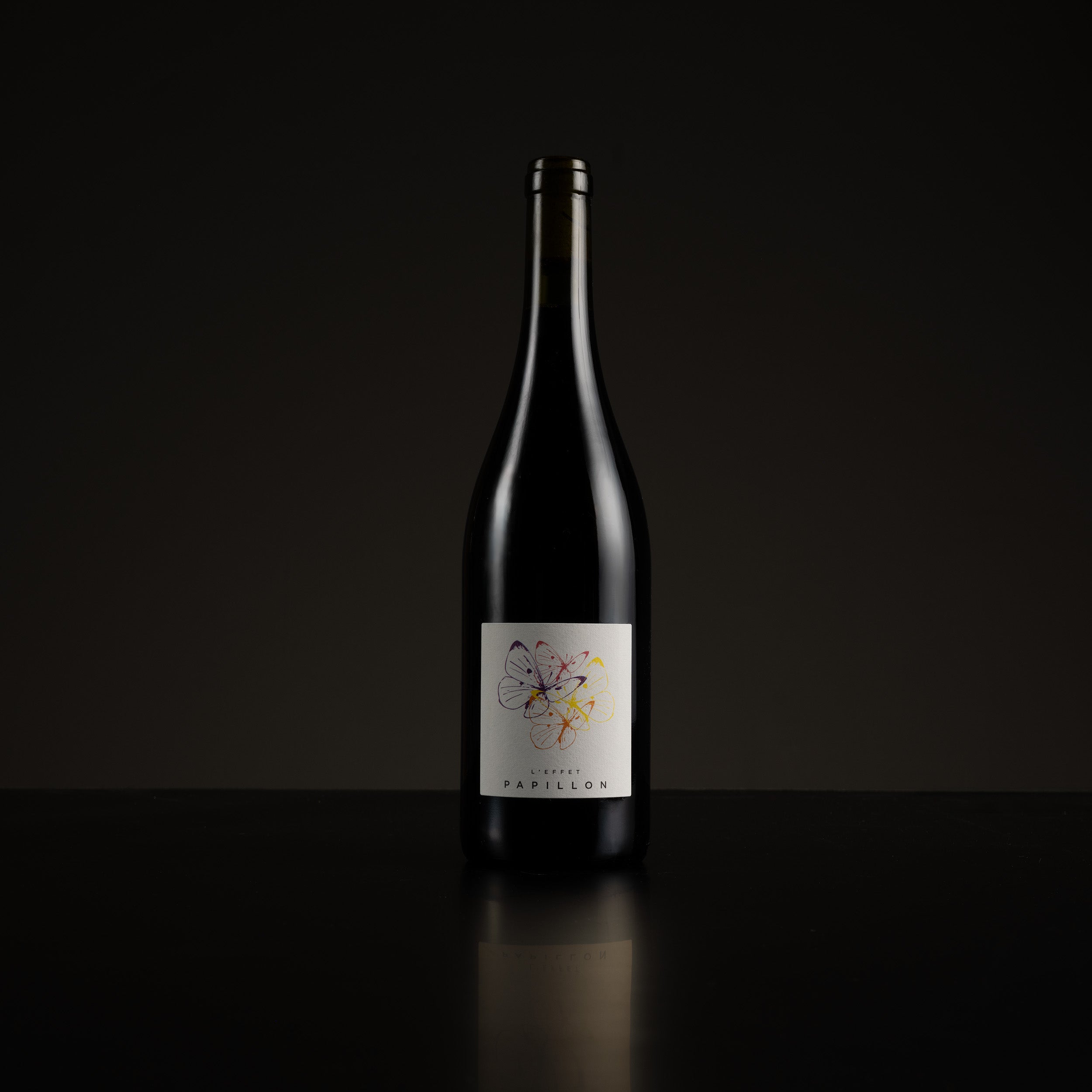 Wine bottle with a label on a black background