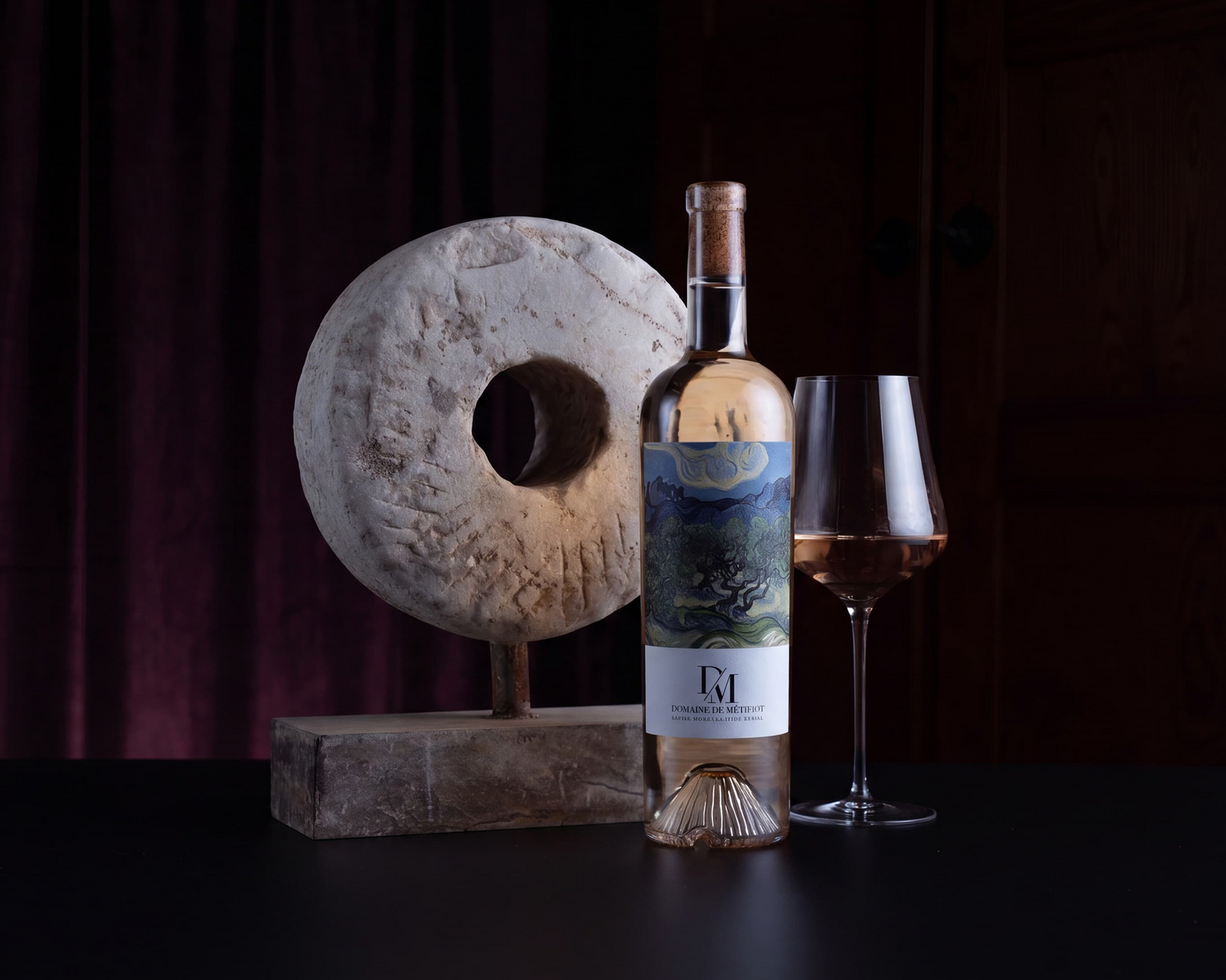 Wine bottle with label and glass on a dark background