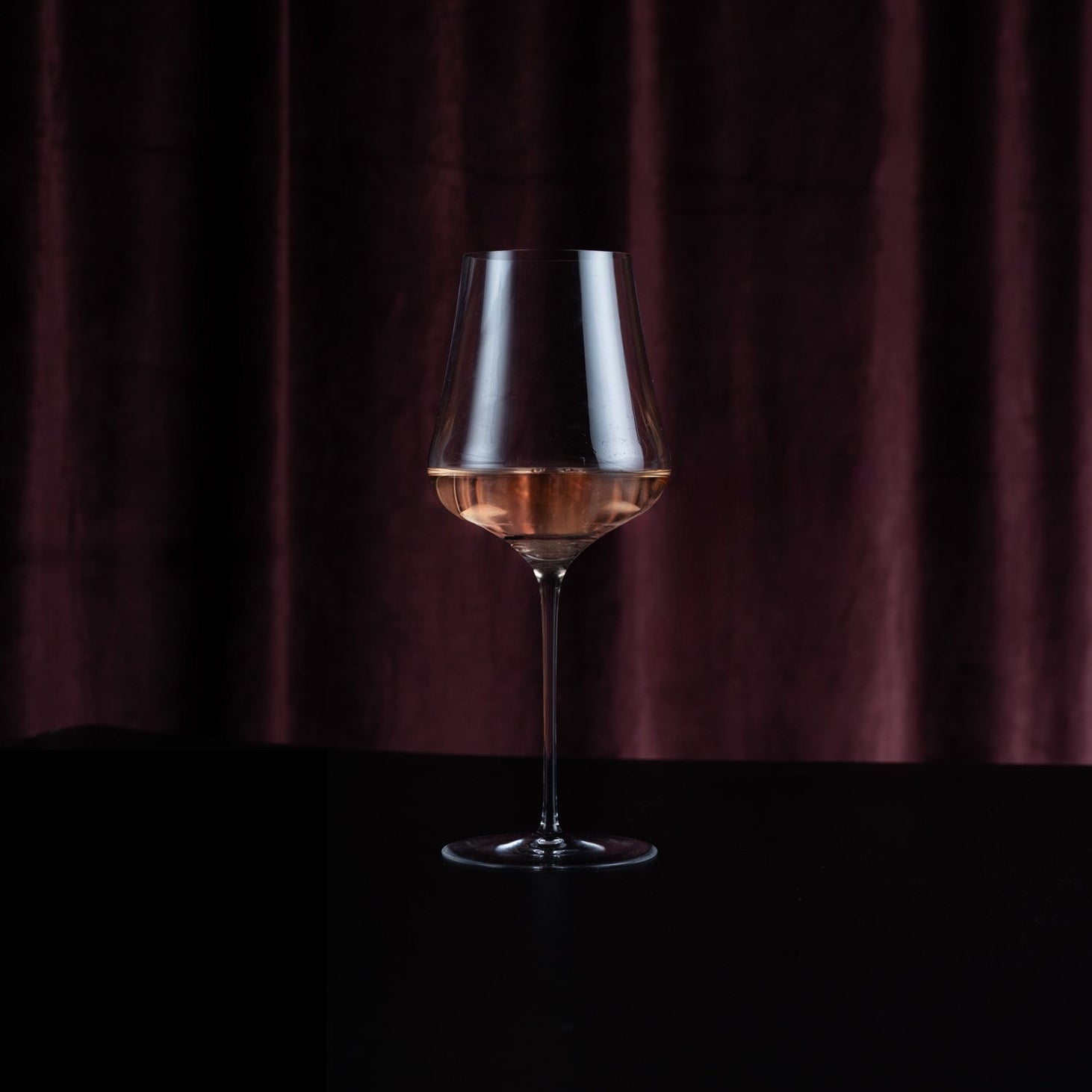 Glass of rose wine on a dark background