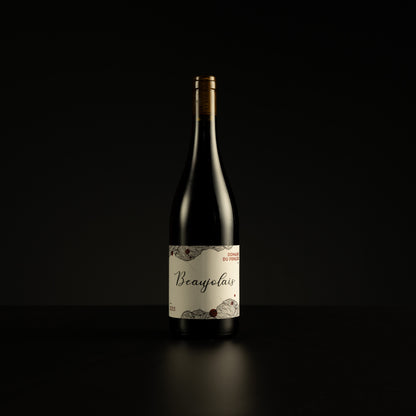 Wine bottle labeled 'Beaujolais' on a black background