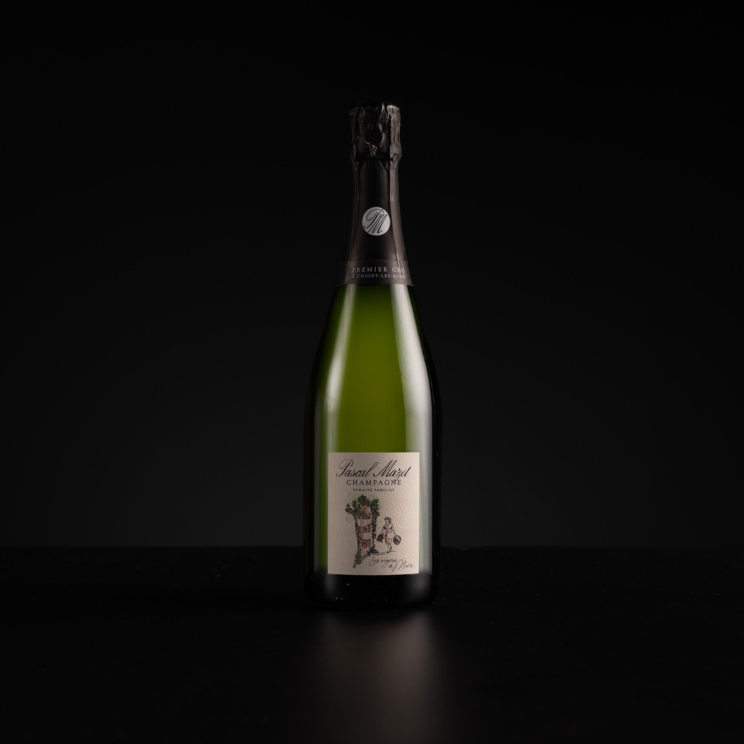 A single bottle of sparkling wine or champagne with a dark green glass body, cream label, and black foil top, photographed against a solid black background.
