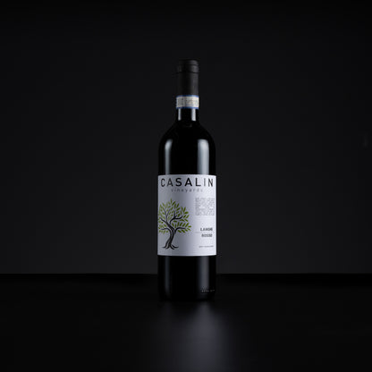 A single bottle of Casalin Vineyards La Vigna Rossa red wine stands centered against a dark black background. The bottle is dark glass with a white label featuring a green tree illustration and black text.