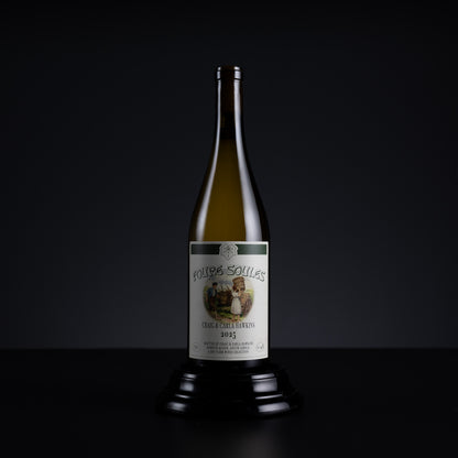 A single vintage wine bottle from the brand Poulies-Souilles, dated 1935, displayed on a black pedestal against a dark studio background.