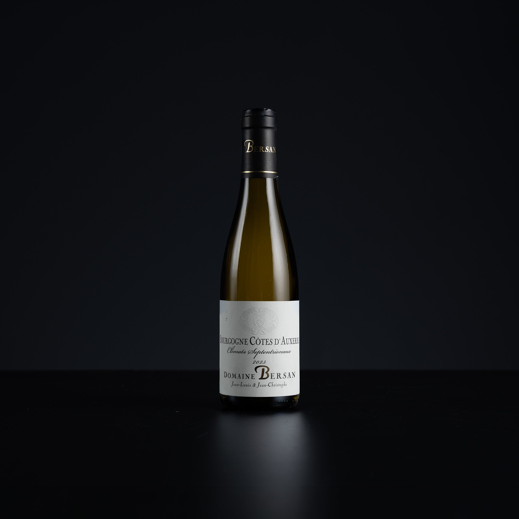 A single bottle of Domains Birkenswank 'Cote des Arthons' white wine centered against a solid black background.