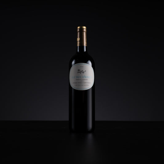 A single dark wine bottle with a gold neck wrap and a white oval label reading 'Les Russes' stands centered against a black background.
