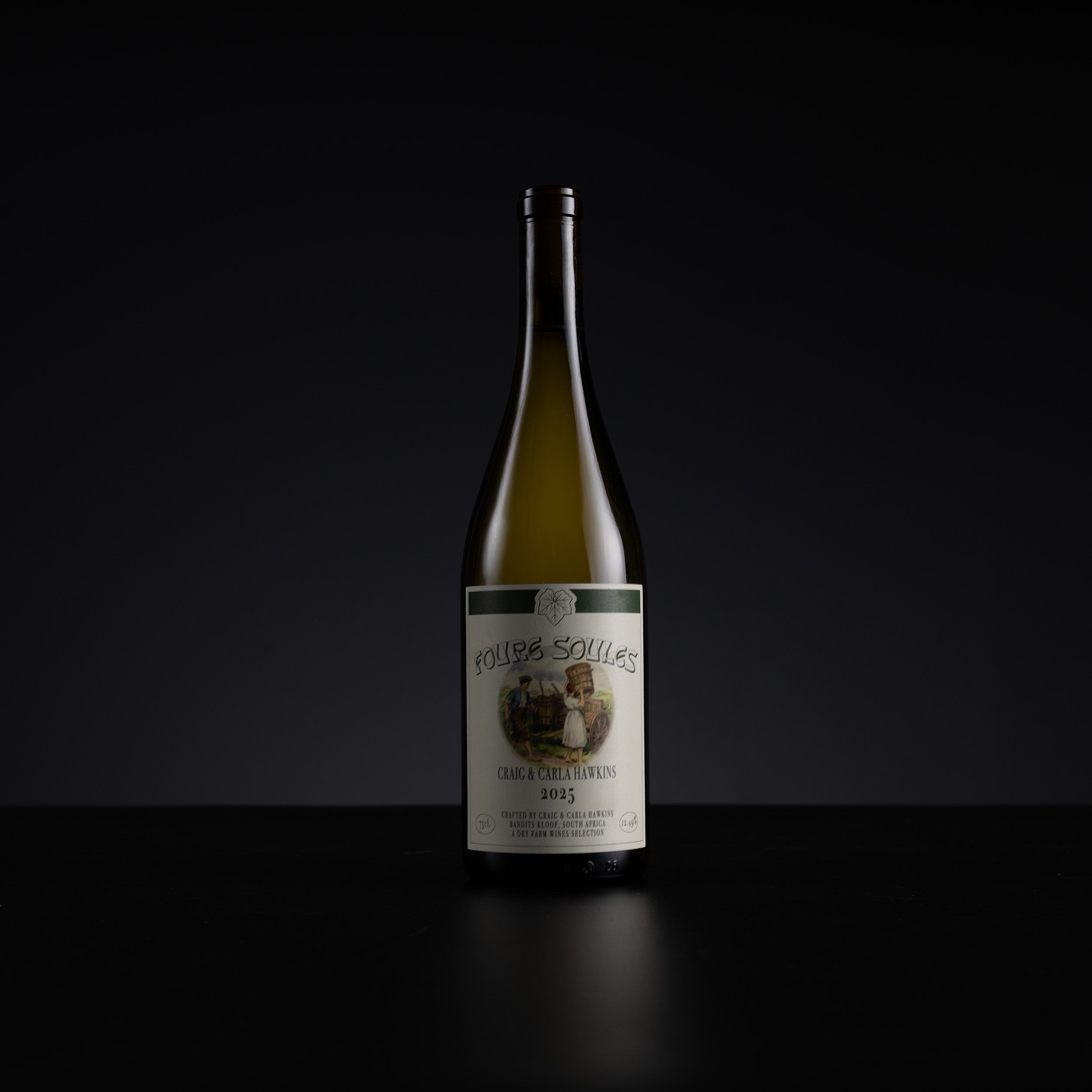 A single bottle of white wine standing upright on a dark surface against a black background. The bottle is pale green glass with a cream-colored label featuring an illustration and the text 'Rouges-Souls' and 'Cru White'.