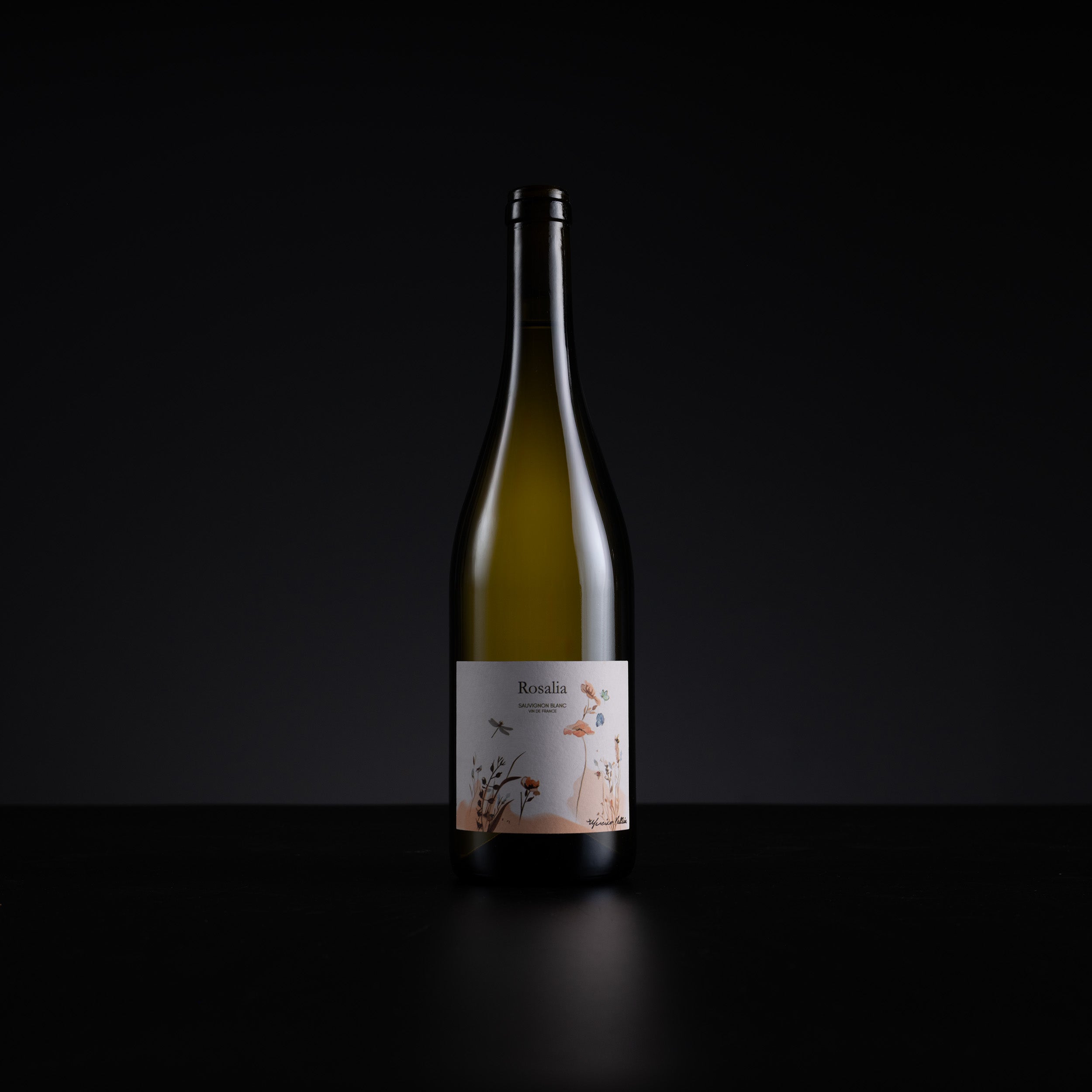 A single bottle of Rosalia Rosé wine with a white label featuring delicate floral illustrations, set against a solid black background.
