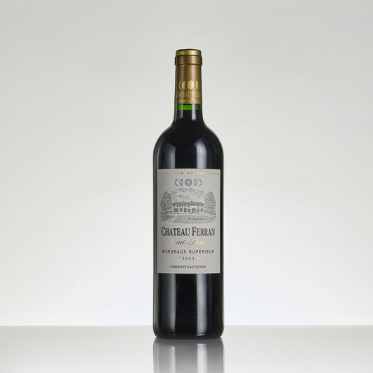 Red wine bottle with Chateau Ferran label on a white background