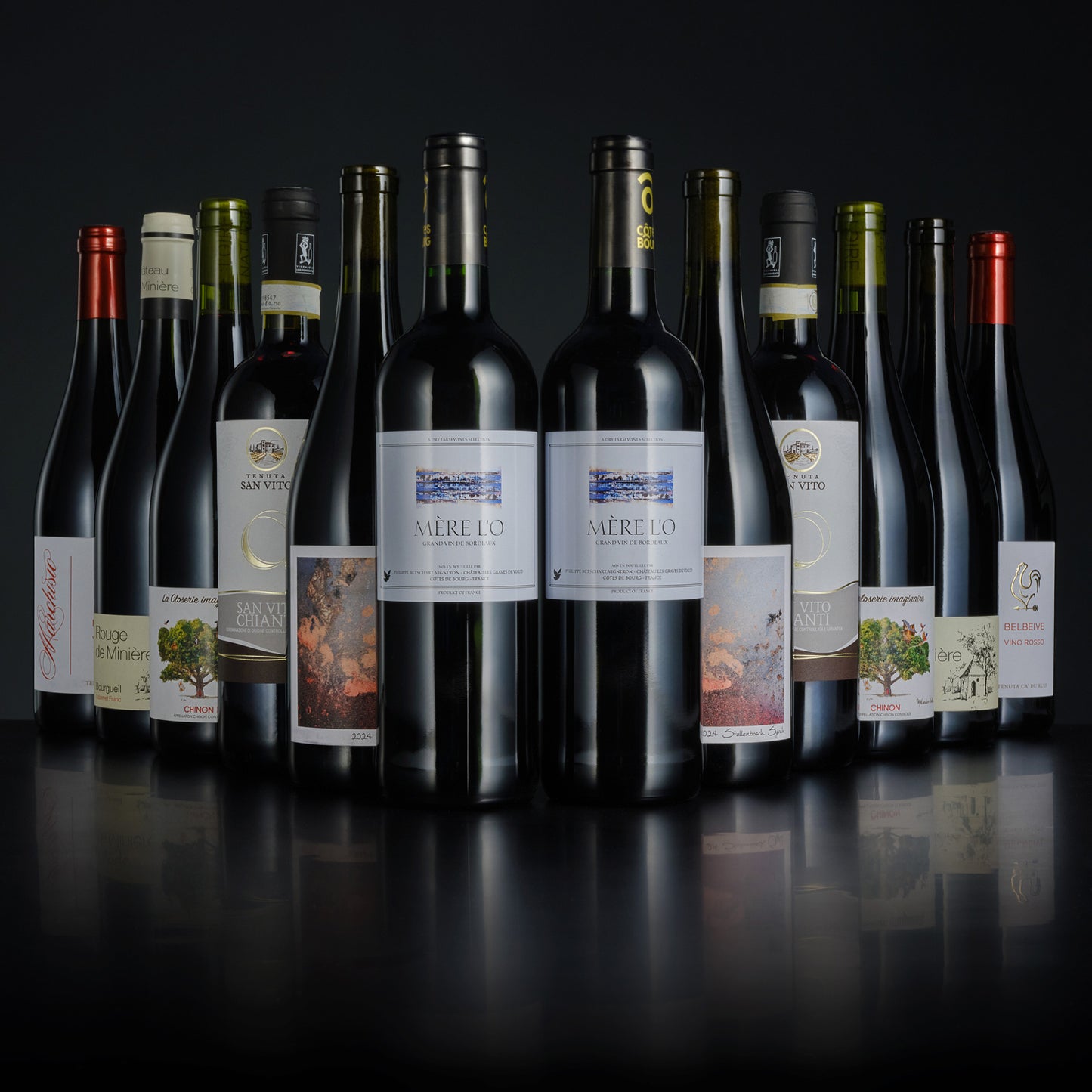 Collection of wine bottles with various labels on a dark background
