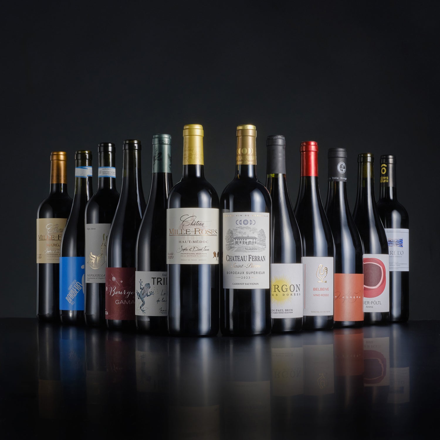 Row of wine bottles with various labels on a dark background