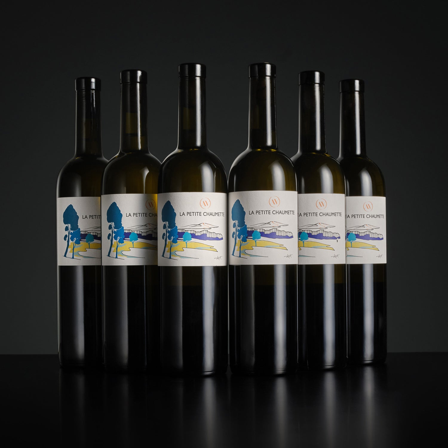 Six bottles of La Petite Chaumette wine arranged in two rows on a dark background