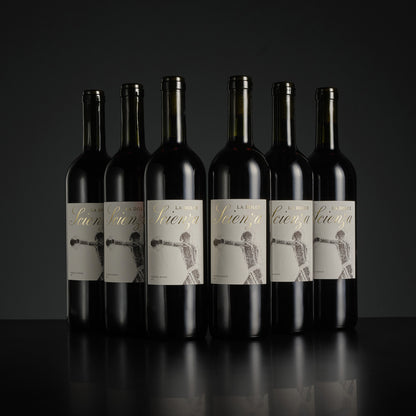 Six bottles of wine with labels on a black background