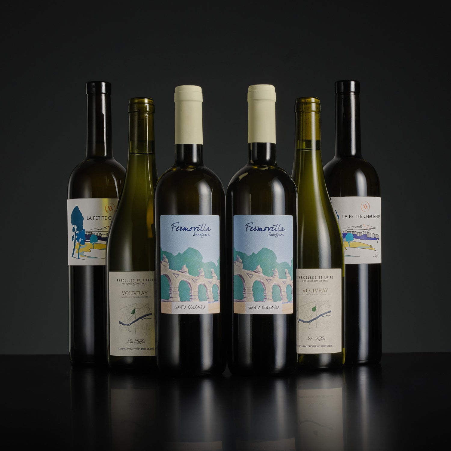 Collection of wine bottles with labels on a dark background